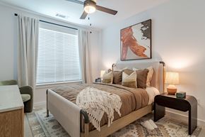 Atlanta apartment for rent - A bedroom with a large bed and a ceiling fan.