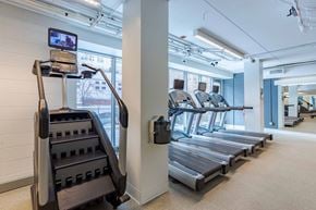 Chicago apartment for rent - A gym with treadmills and a television on the wall.