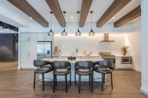 Chicago apartment for rent - Two black chairs are in front of a kitchen island.