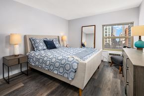 Chicago apartment for rent - a bedroom with a large bed and a window
