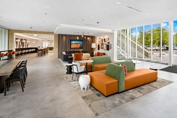 Chicago apartment for rent - A modern living room with a long table and chairs.