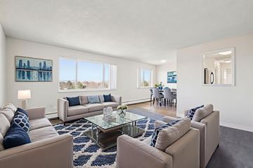 Denver apartment for rent - A living room with a glass coffee table and two couches.