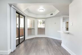 Scottsdale apartment for rent - the living room of an apartment with wood flooring and sliding glass doors