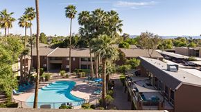 Phoenix apartment for rent - an aerial view of a resort with a swimming pool and palm trees