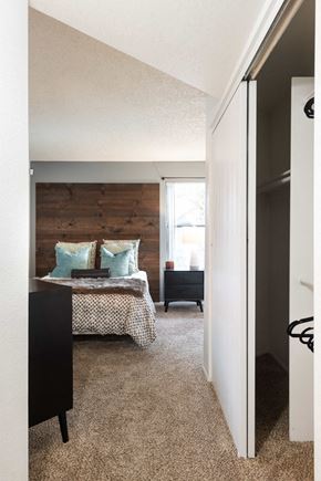 Phoenix apartment for rent - a bedroom with a bed and a wooden accent wall