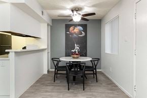 Phoenix apartment for rent - a dining room with a table and chairs and a ceiling fan