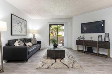 Phoenix apartment for rent - a living room with a black couch and a tv