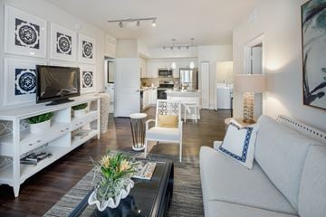 Plantation apartment for rent - A living room with a white couch and a glass coffee table.