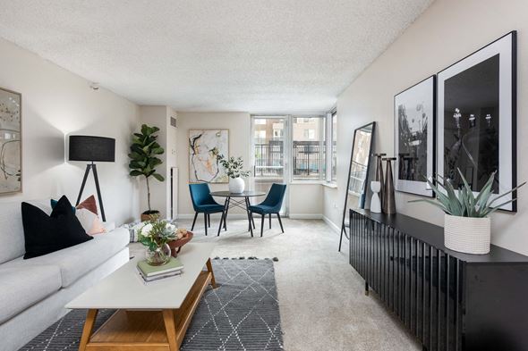 Denver townhouse for rent - a living room with a white couch and a table and chairs