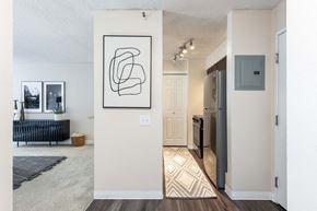 Denver townhouse for rent - an open living room and kitchen with a refrigerator and a sink