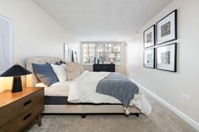 Denver townhouse for rent - a bedroom with a bed and a dresser and a window