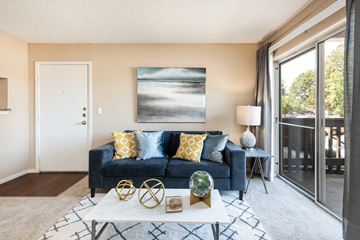 Aurora apartment for rent - a living room with a couch and a coffee table and a sliding glass door