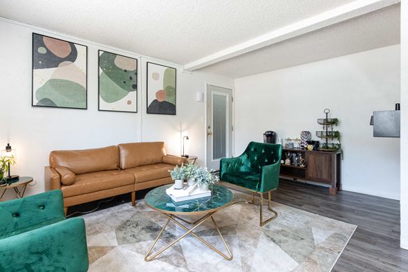 Aurora apartment for rent - a living room with green chairs and a brown couch