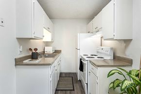 Aurora apartment for rent - a kitchen with white appliances and counters and white cabinets