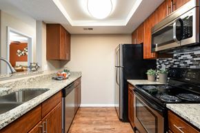 Denver apartment for rent - a kitchen with stainless steel appliances and granite counter tops
