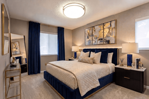 Aurora apartment for rent - A bedroom with a large bed and a painting above it.