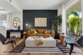 Wilton Manors townhouse for rent - A modern bedroom with a large bed and a striped rug.