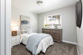 Las Vegas apartment for rent - a bedroom with a bed and a dresser and a window