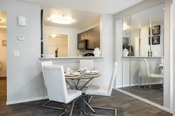 Las Vegas apartment for rent - a dining room with a table and chairs and a kitchen