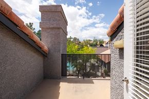 Las Vegas apartment for rent - a balcony with a view of a pool and a gate