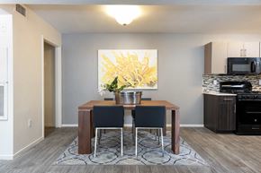 Las Vegas apartment for rent - a dining room with a table and chairs and a kitchen