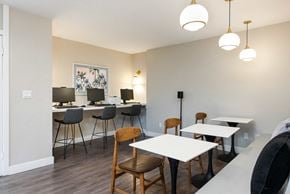Henderson townhouse for rent - a dining room with tables and chairs and a counter with lamps