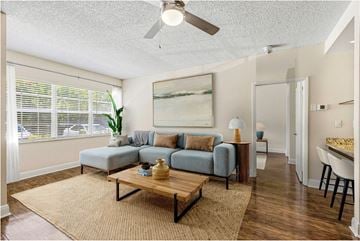 Hollywood apartment for rent - A living room with a grey couch, a wooden coffee table, and a painting on the wall.