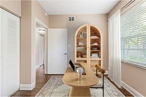 Hollywood apartment for rent - A dining room with a wooden table and chairs.