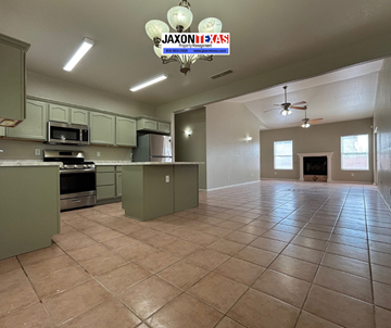 El Paso apartment for rent - A kitchen with green cabinets and a tile floor.