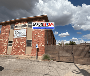 El Paso apartment for rent - A building with a sign that says "Jaxon Property Management" in front of it.