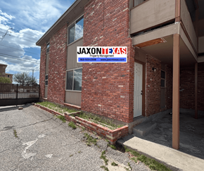 El Paso apartment for rent - A brick building with a sign that says "Jaxonixas" on it.