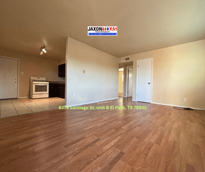 El Paso apartment for rent - Empty room with wooden flooring and a JAXON REDS sign on the wall.