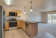 Moorhead apartment for rent - A kitchen with wooden cabinets and stainless steel appliances, Kassenborg Apartments, Moorhead, MN
