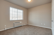 Moorhead apartment for rent - A room with a window and a wall-mounted air conditioner.