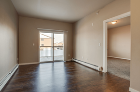 Moorhead apartment for rent - A room with a sliding glass door leading to a balcony.