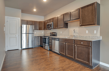 Moorhead apartment for rent - A kitchen with wooden cabinets and stainless steel appliances.