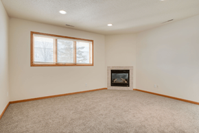 Fargo townhouse for rent - A room with a fireplace and a window.