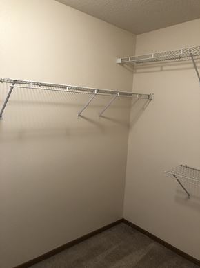 Fargo apartment for rent - Empty walk-in closet with shelves and hangers.