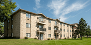 Forest Lake apartment for rent - a brick apartment building with balconies and a green lawn at Autumn Hills Apartments, Forest Lake, 55025