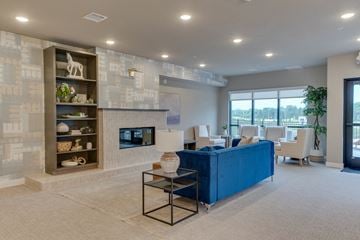 Hudson apartment for rent - a living room with a blue couch and a fireplace