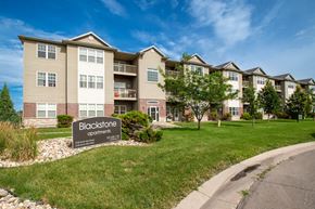 Fargo apartment for rent - an apartment building with a sign that reads bioscience commons at BlackstoneApartments, Fargo, ND, 58104