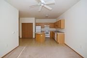 Clearwater apartment for rent - an empty kitchen with a ceiling fan and wooden cabinets at Cedar Ridge Apartments, Clearwater, 55320