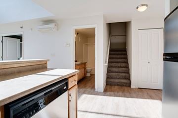 Fargo apartment for rent - a kitchen with a sink and a stove and a staircase in a home with stairs at Urban Crossing Apartments, Fargo