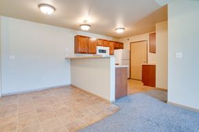 Moorhead apartment for rent - a kitchen and living room with a microwave and a refrigerator at Waterstone Apartments, Moorhead, MN, 56560