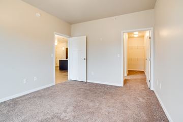 Fargo apartment for rent - a spacious living room with carpeting and white walls