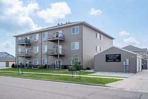 Moorhead apartment for rent - a large apartment building with balconies and a sign that reads condominium  at Courtyard Apartments, Moorhead, 56560