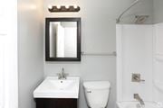 Grand Forks apartment for rent - a small bathroom with a sink toilet and shower at Southern Manor Apartments, Grand Forks, North Dakota