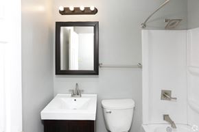 Grand Forks apartment for rent - a small bathroom with a sink toilet and shower at Southern Manor Apartments, Grand Forks, North Dakota