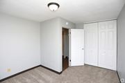 Grand Forks apartment for rent - a bedroom with two closets and a carpeted floor at Southern Manor Apartments, North Dakota