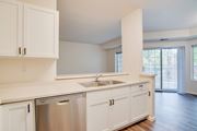 Fargo apartment for rent - A kitchen with white cabinets and a stainless steel dishwasher.